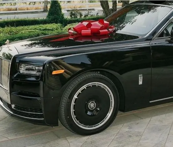 Smile showing off a cool new car worth tens of thousands of dollars as a gift from her husband